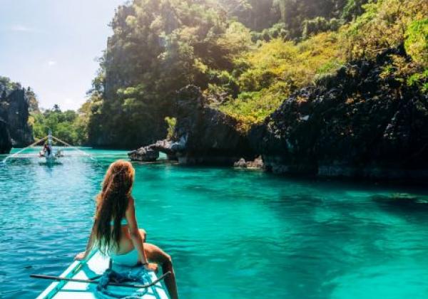 back-view-of-the-young-girl-relaxing-on-the-boat-and-looking-at-the-island-travelling-tour-in-asia-el-nido-palawan-philippines