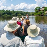 tourist-group-arriving-at-amazon-rainforest-lodge-by-canoe,-yasuni-national-park,-ecuador